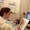 Cassidy doing homework from her hospital bed.