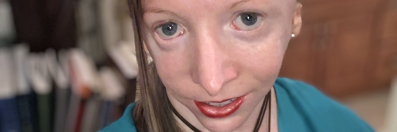 Learning Self-Compassion as a Bullying Survivor Cynthia wearing a blue cardigan over white blouse.