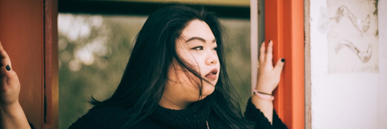 7 Things Everyone Experiencing Medically-Induced Menopause Should Know woman standing in doorway