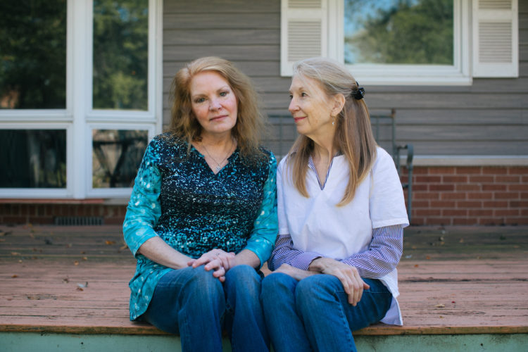 Arline Feilen (left) and her sister, Kathy McCoy, at their mother’s home in the Chicago suburbs. With the biggest chunk of Feilen’s bill being $16,480 for four nights in a psychiatric unit room shared with another patient, McCoy joked that it would have been cheaper to stay at the Ritz-Carlton hotel. (Alyssa Schukar for KHN)