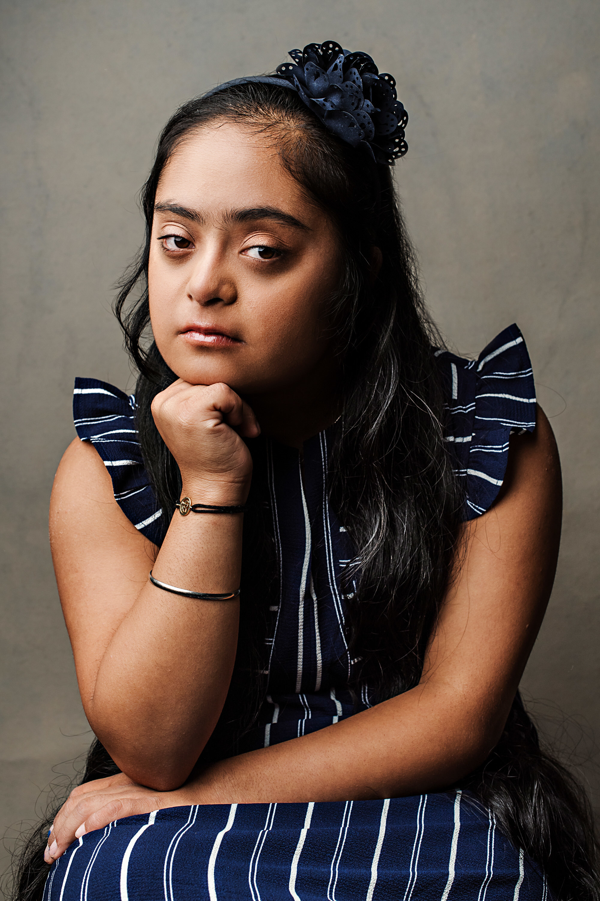 Bandagi Jaggi, girl with Down syndrome wearing a blue striped dress.