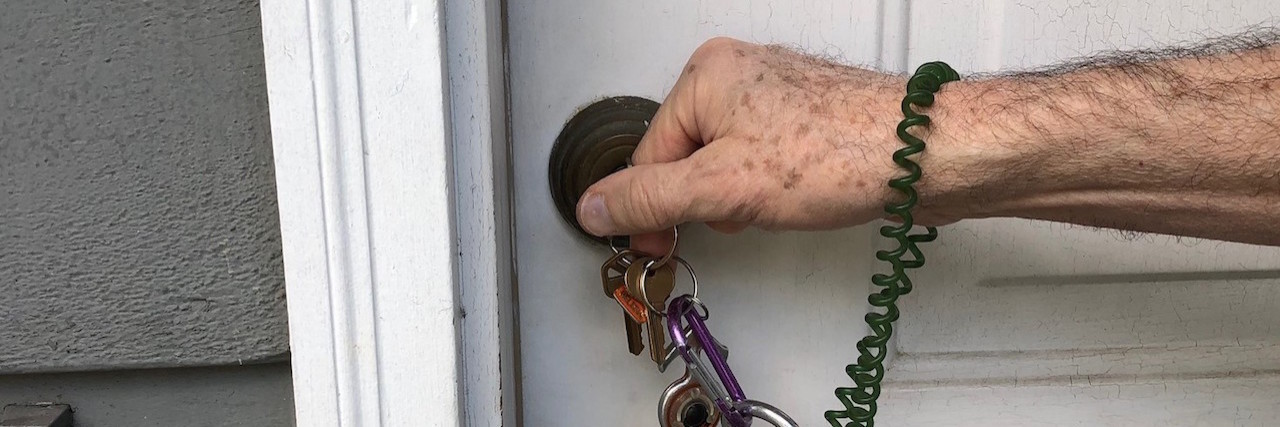 7 Habits That Help People With Parkinson's Disease Close up of the author's hand unlocking the door