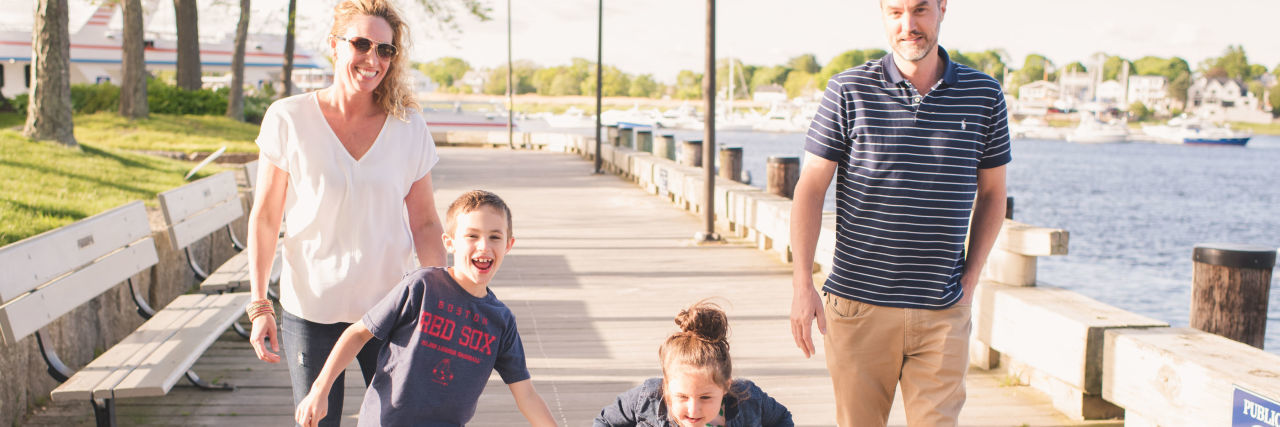 Parenting a Child With Hereditary Spastic Paraplegia Type 47 the author and her family smiling