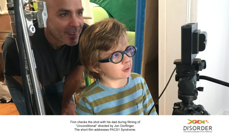 The filmmaker with their son, near the video camera 
