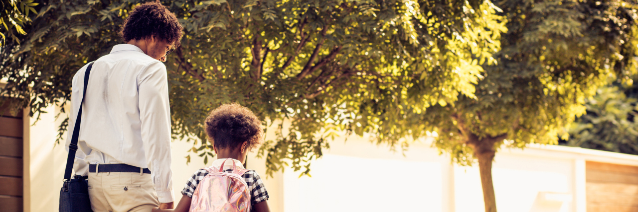 Diabetes and Genetics: Is Your Child At Risk? father and his daughter walking trough park. From back.