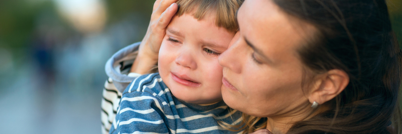 Feeling Mom Guilt as a Parent of a Child With a Rare Disease A mother holding and comforting an upset baby boy