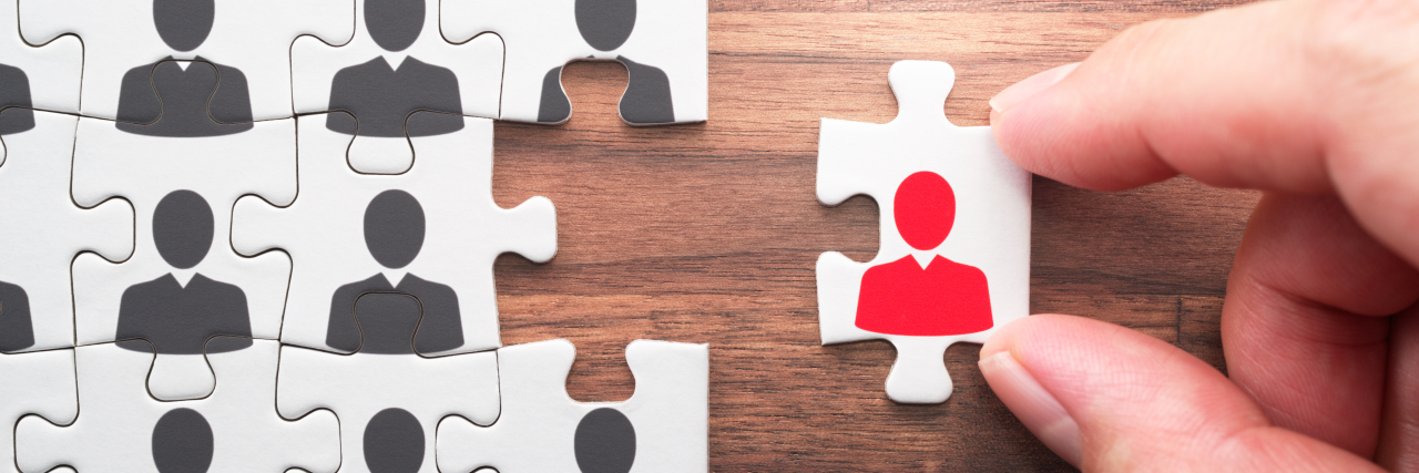 Facing Employment Discrimination as a Wheelchair User in the U.K. Puzzle piece with human silhouette.