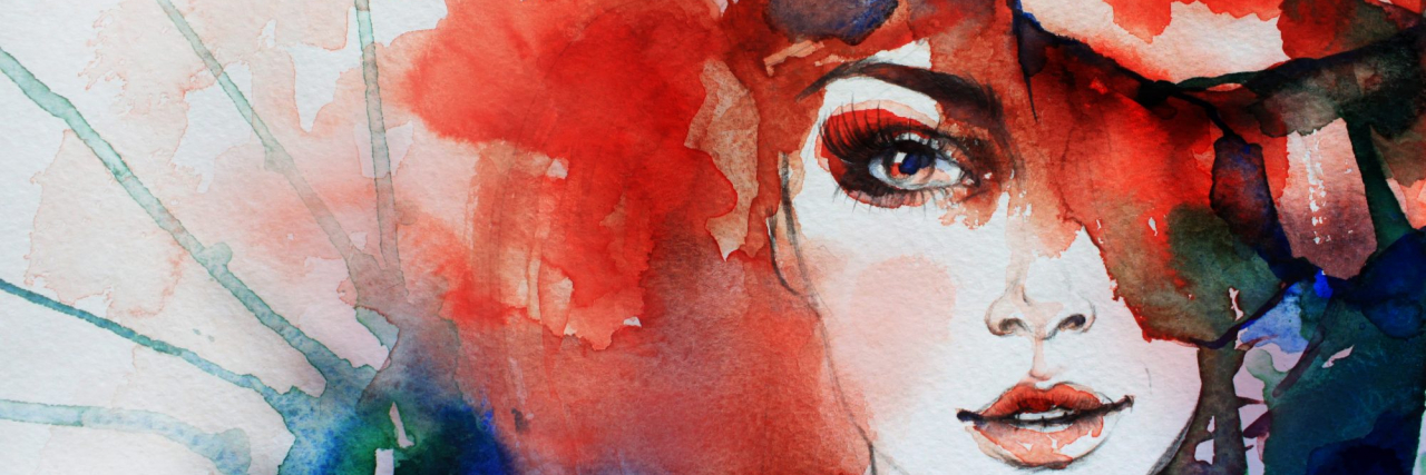 watercolor of a woman's face with red and blue and green colors surrounding