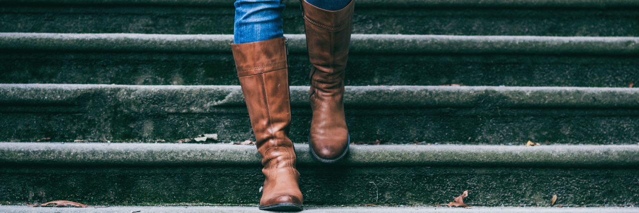 Undifferentiated Connective Tissue Disorder and Chronic Pain woman walking down the stairs wearing boots