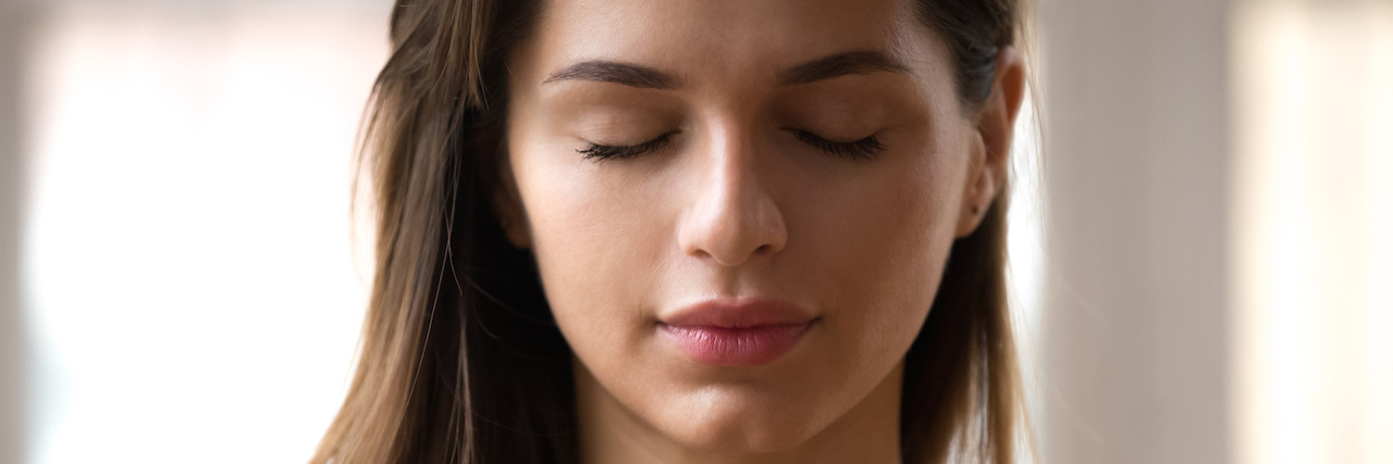 Practice Self-Compassion With Breath and Thought Exercise Woman with eyes closed and looking peaceful