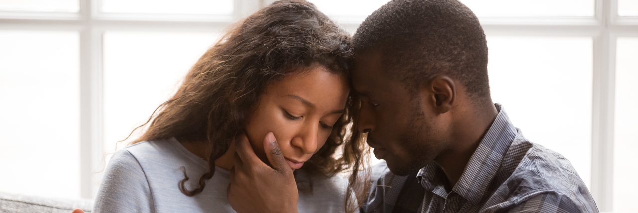 Sex and Intimacy When a Partner Lives With Chronic Illness Couple holding each other tenderly.