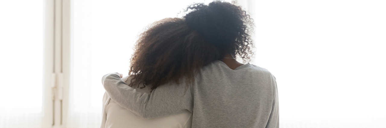 What I've Learned About My Daughter's OCD back of a black mother and daughter, the mother's arm is around the daughter with her head resting on her shoulder