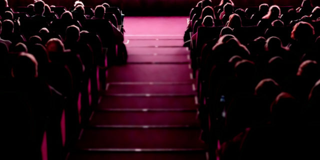 Why We Must Change How Dwarfism Is Portrayed in Theatre People in theatre audience.