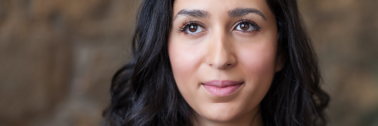 How Does Transcranial Magnetic Stimulation Work for Depression? Spanish Woman looking away at the office. She is lost in her thoughts. Sadness