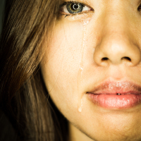 an asian woman crying