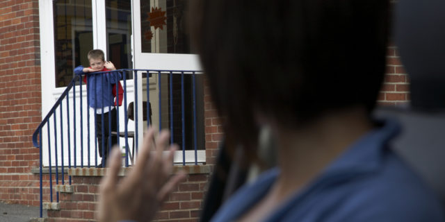 6 Things I Want My Chronically Ill Child's School to Know About My Parenting a mother waving to her son outside of a school