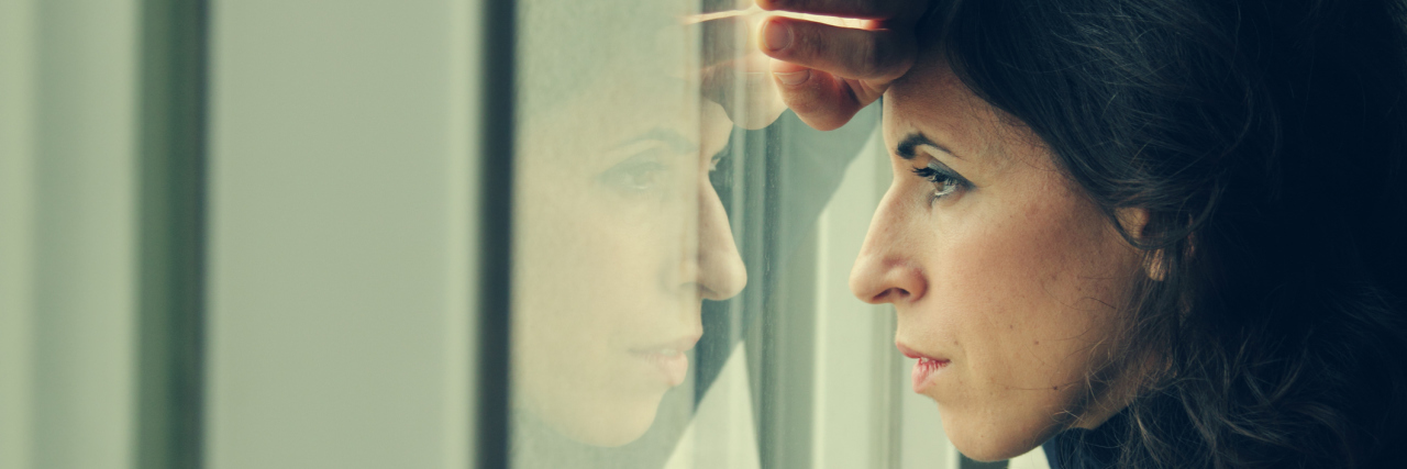Finding Your Way With Bipolar Disorder A woman stares intensely out of a window.