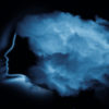 a woman's silhouette with white clouds