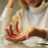 Close up of woman hands holding a pills.
