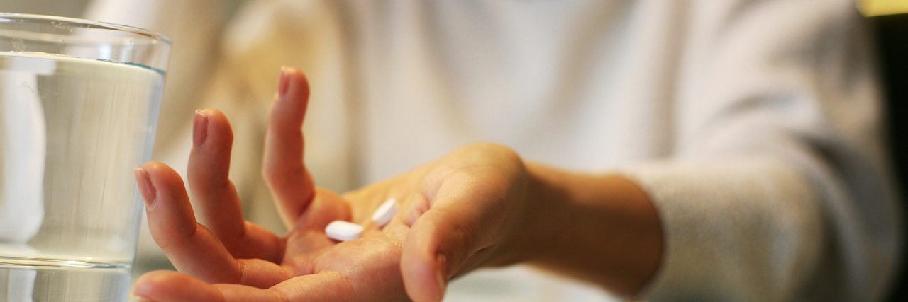 FDA Approves New Eli Lilly Medication Reyvow for Acute Migraine Close up of woman hands holding a pills.