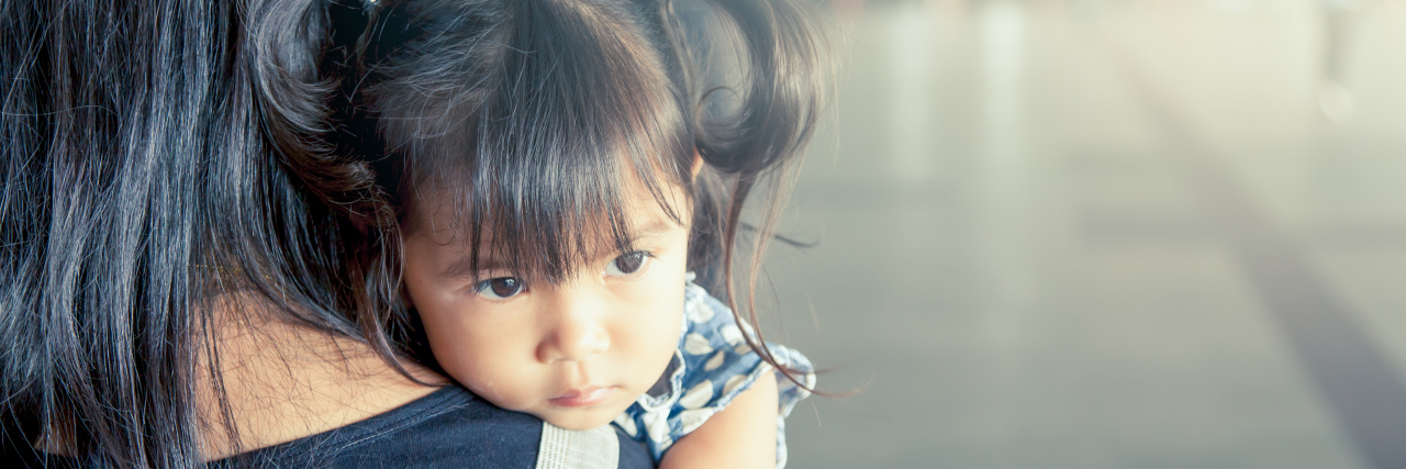 To the Moms Battling Suicidal Thoughts, Please Stay a little girl resting her chin on her mother's shoulder