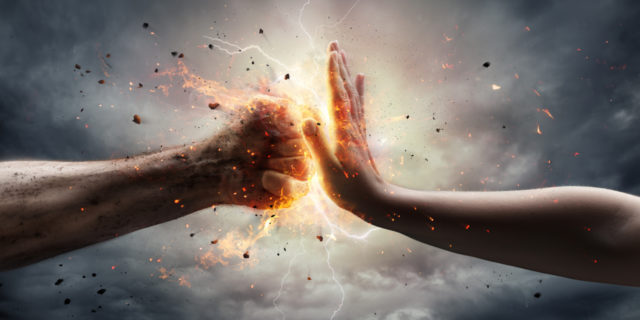 What It's Like to Fight the Dermatomyositis 'Beast' Inside Me fist coming up against a hand, trying to stop it. image of thunderstorm.