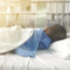blurry hospital bed with a child