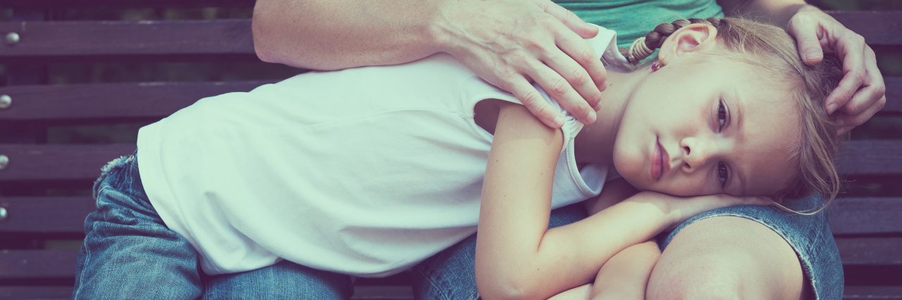 Way to Help a Child With Chronic Pain Communicate a sad girl laying on her mom's lap