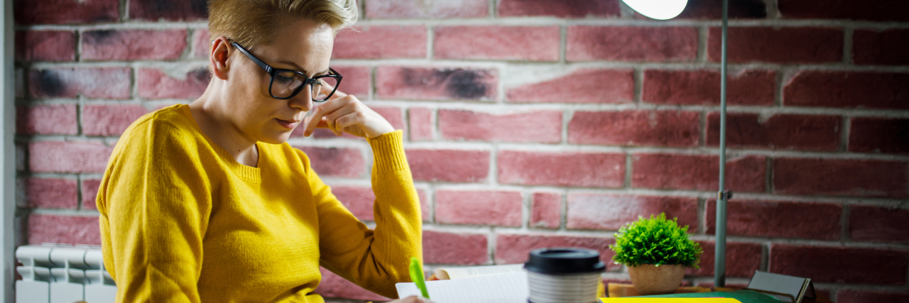 5 Tips for Managing Brain Fog Woman writing in journal.