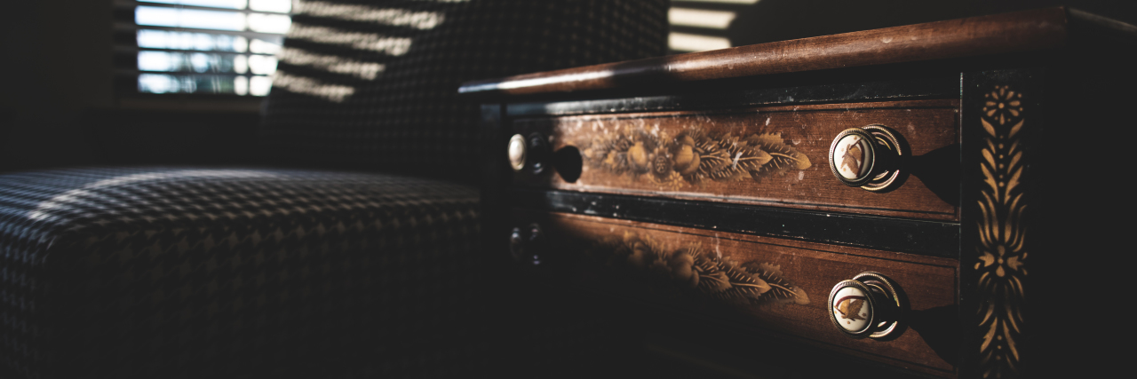 Where I Put My 'Friend' Migraine When Doctors Can't Make Her Go Away an office with a couch and a chest drawer