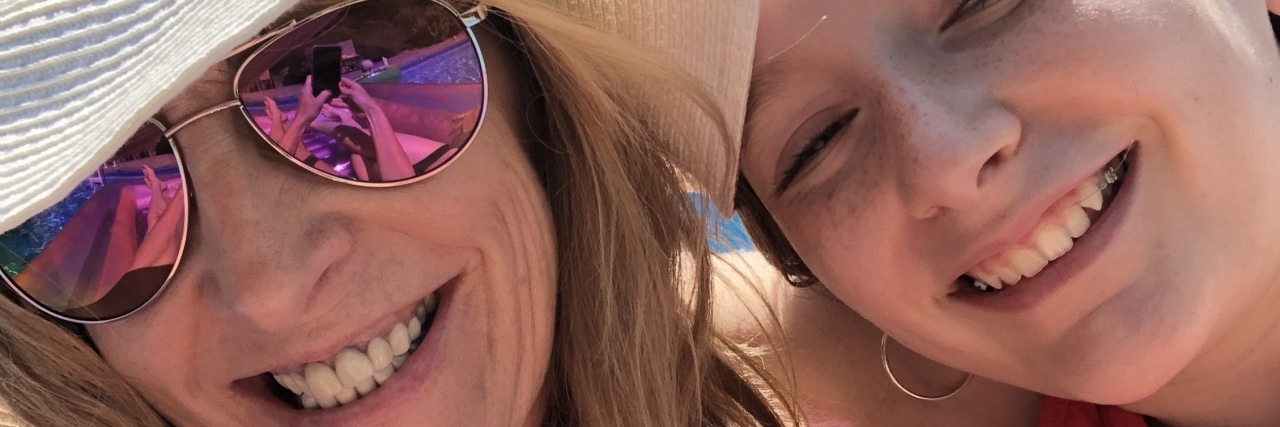 Wearing Many Hats While Parenting a Child With Autism Kathy wearing a white floppy hat.