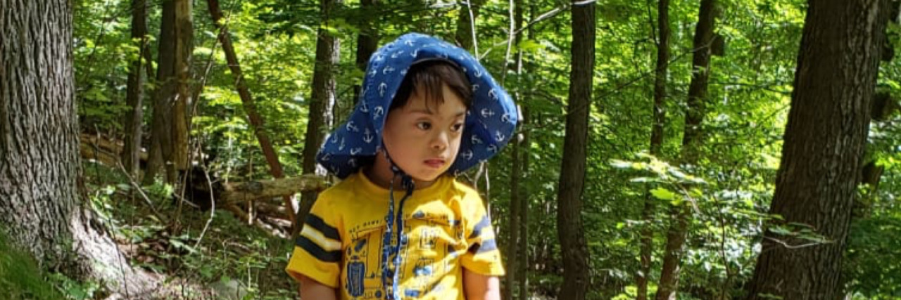 Busting Myths for Down Syndrome Awareness Month Smriti's son playing in the woods.