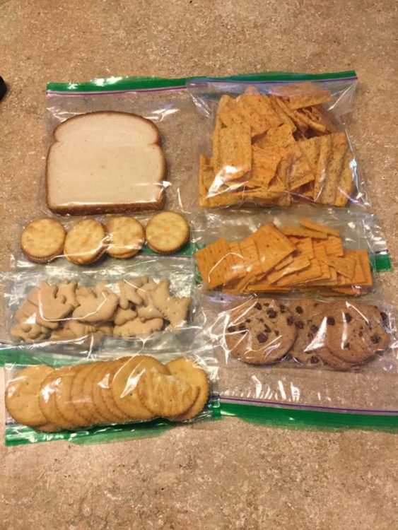 Plastic ziploc baggies with a sandwich, crackers, cookies, chips, etc.