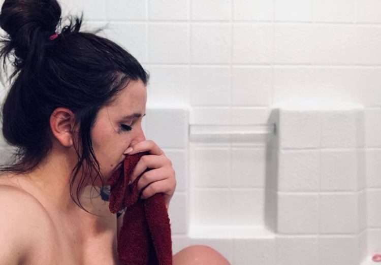 woman crying in bathtub