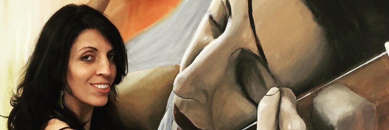 Expressing My Feelings About Hearing Loss Through Art Priscila Soares painting her self-portrait.