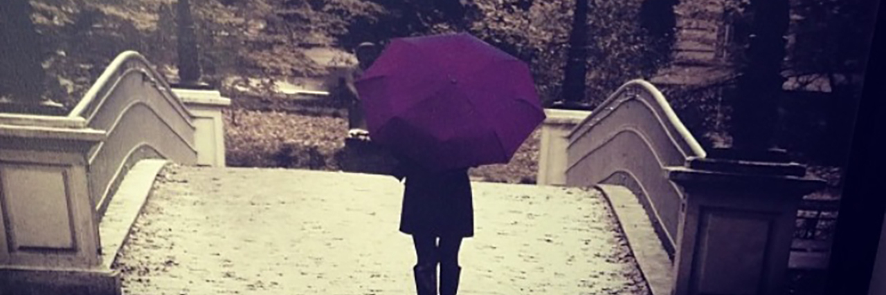 Woman with purple umbrella.
