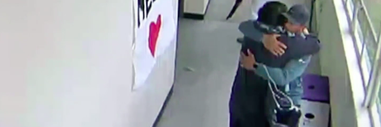 What to Know About Viral Video of Coach Hugging Armed Suicidal Student Viral video screenshot of coach hugging student with shotgun