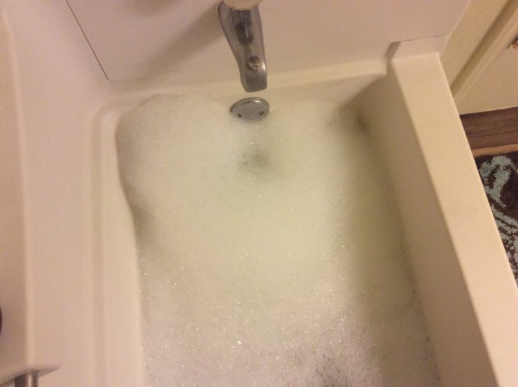 Bathtub filled with bubbles.