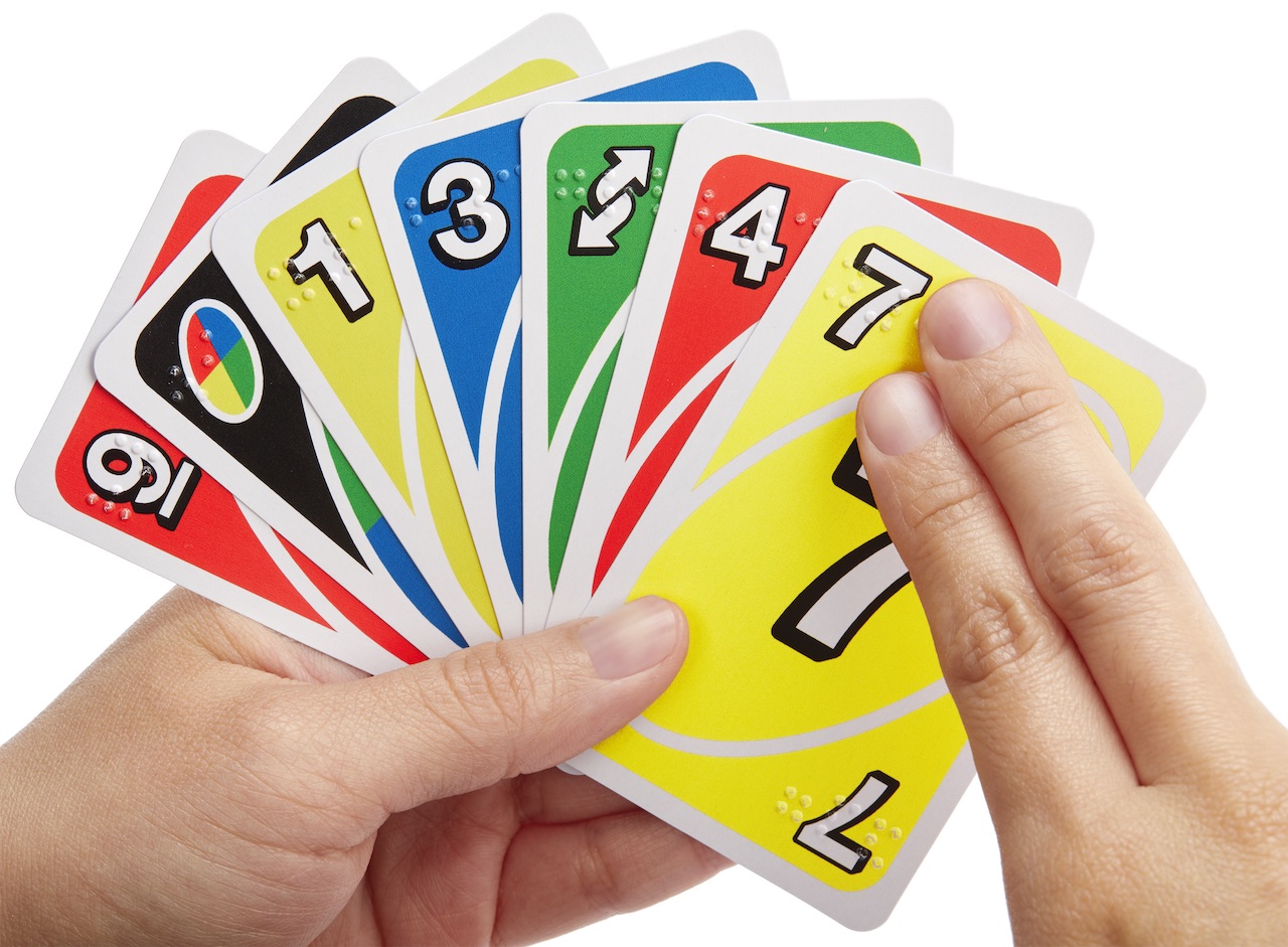 Hands holding UNO Braille Cards