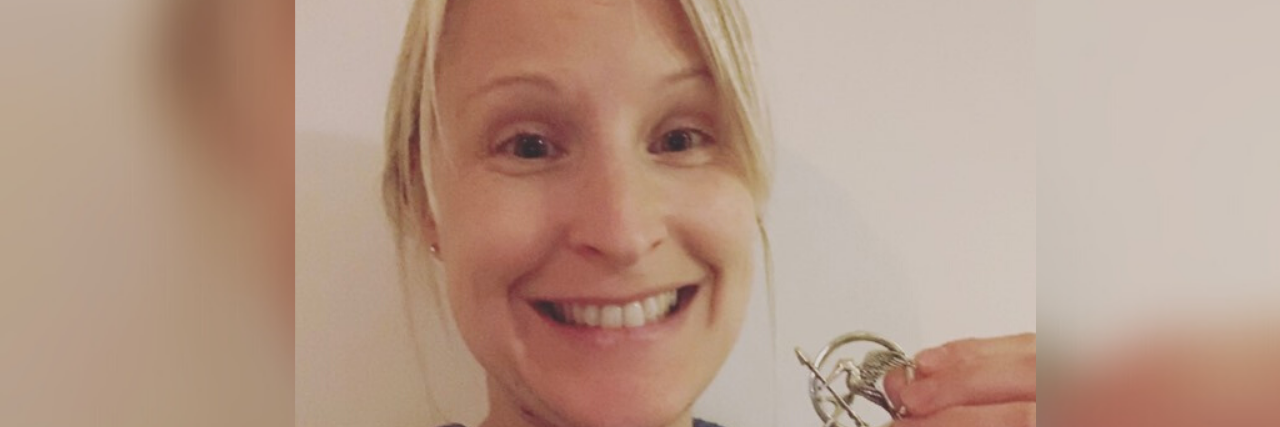 To My Fellow 'Hunger Games Mums' I Met at the Hospital A woman holding a Hunger Games symbol