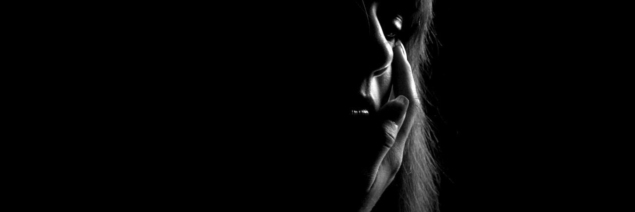 Feeling Like I Have No Other Options Made Me Want to Die by Suicide black and white photo of woman with hand raised to cheek, eyes closed