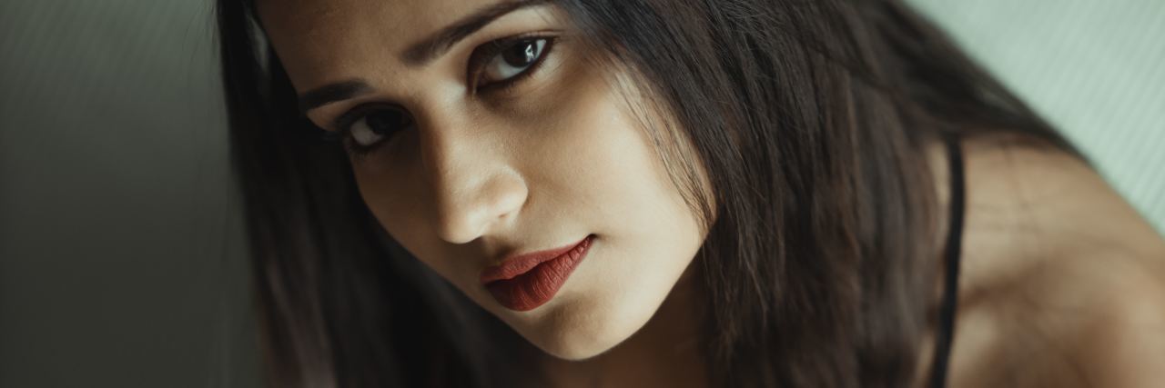 The Problem With World Mental Health Day in India photo of young woman looking up into camera with sad expression