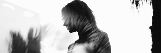 black and white photo, double exposure of woman silhouette against leaves