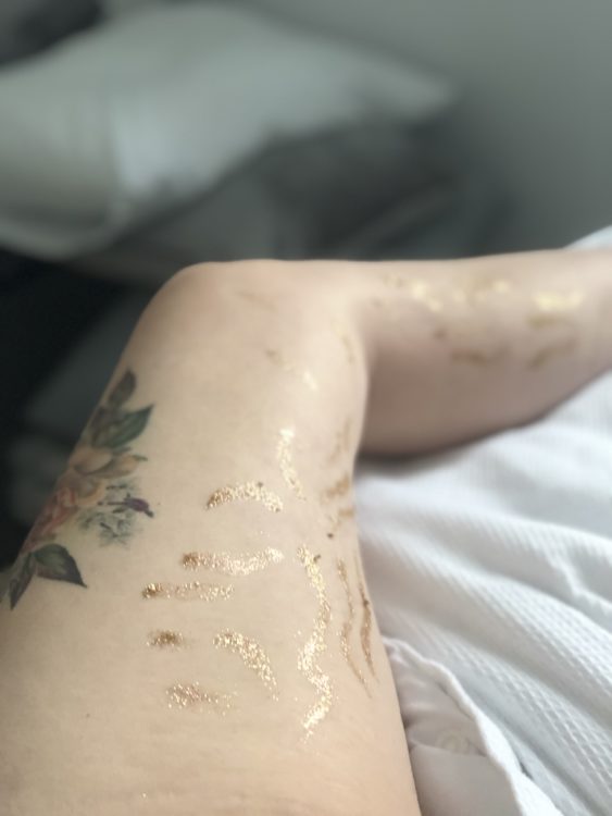 A photo of a woman's leg with tattoos.