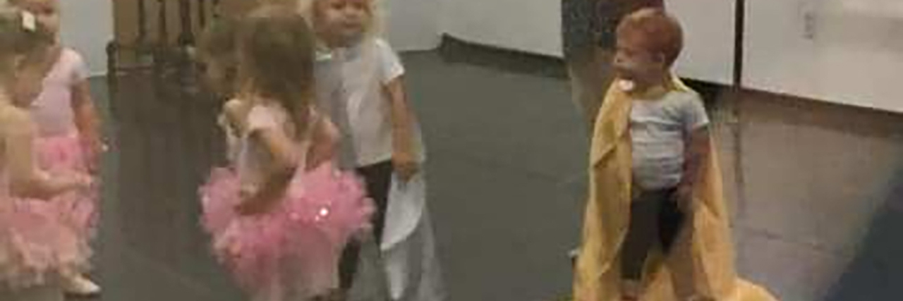 Including Kids With Down Syndrome in Ballet Class Jameson wearing a gold cape at ballet class.