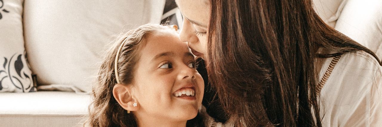 Tips for Parenting With Bipolar Disorder photo of mother and daughter, the daughter smiling at the mother