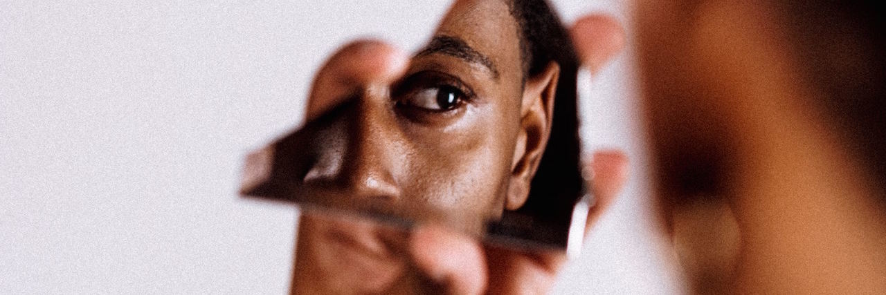 Using Mario Cart to Explain Bipolar Disorder A man looking at himself in a piece of broken mirror