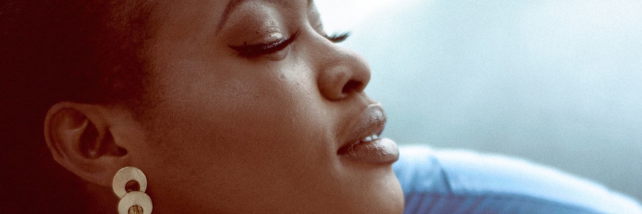 Bipolar Disorder: How to Get Through the Day With Bad Thoughts A woman with her eyes closet, head lifted up