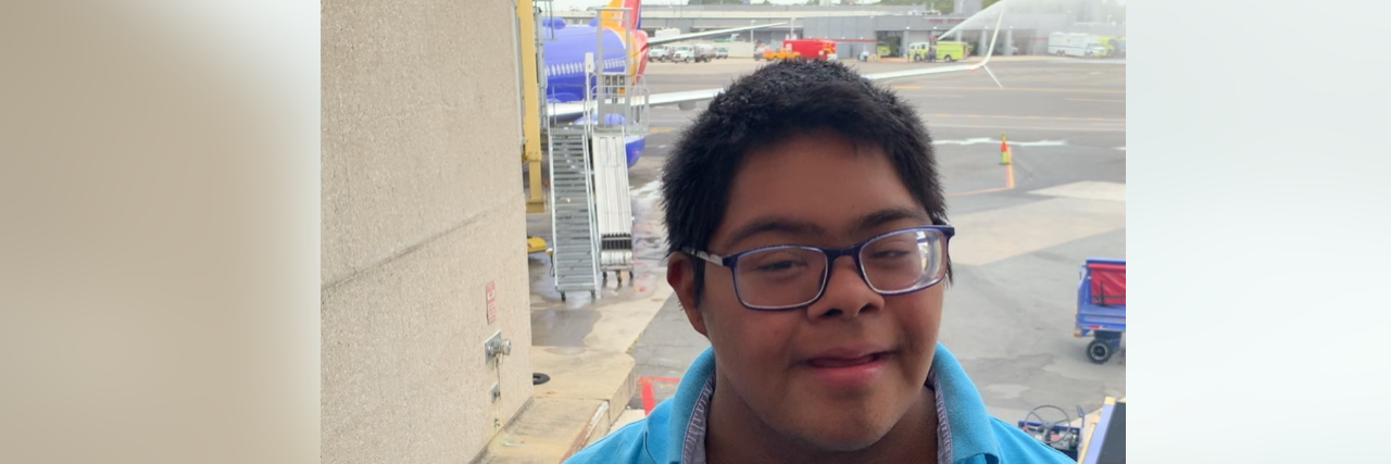 Teaching People With Down Syndrome Independent Air Travel Skills Raymond, a teen with Down syndrome at the airport.