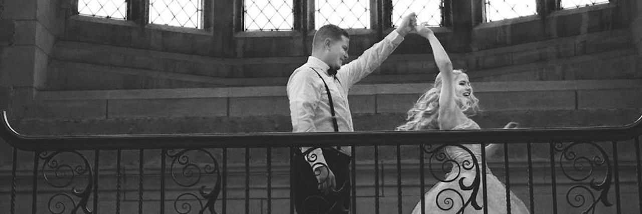 How to Talk About Your Chronic Illness in a Relationship PIcture of author's husbaand spinning author in white dress in a chapel